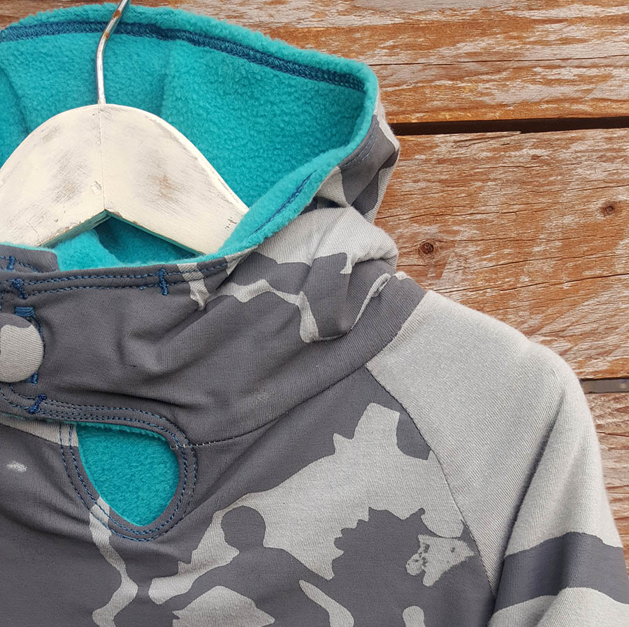 Kid's reversible hoody in jade/light grey - close up Kid's reversible hoody in jade/light grey - close up